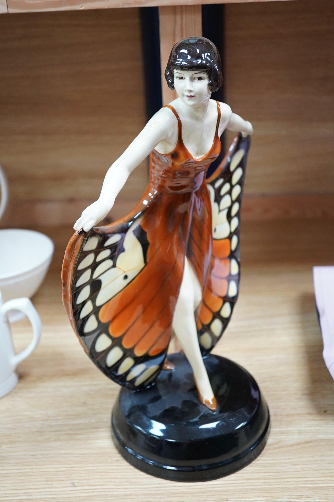 A Lorenzl Goldscheider butterfly dancer figurine, stamped to the base, restored, 42cm high